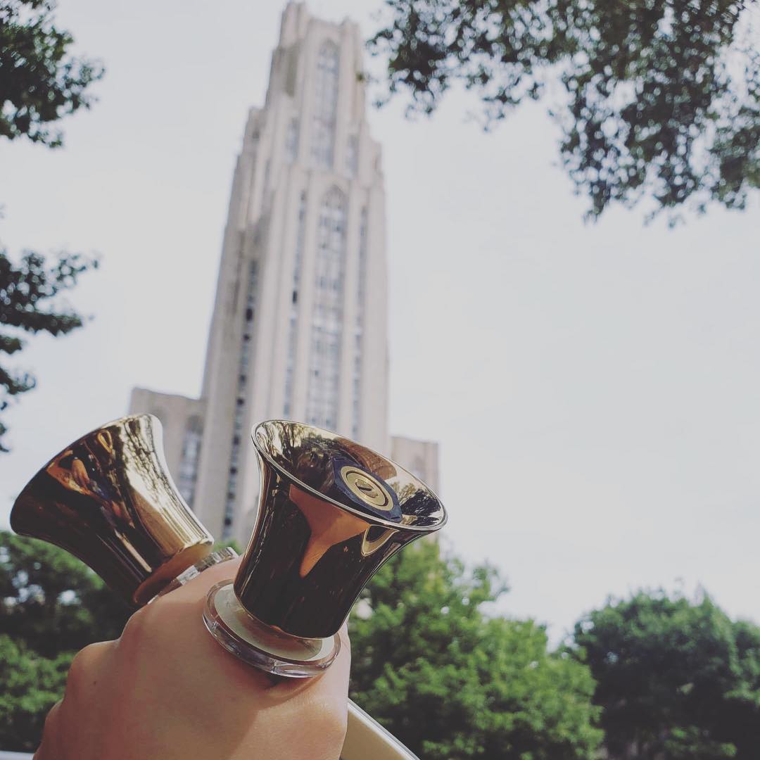 handbells being held in front of a building